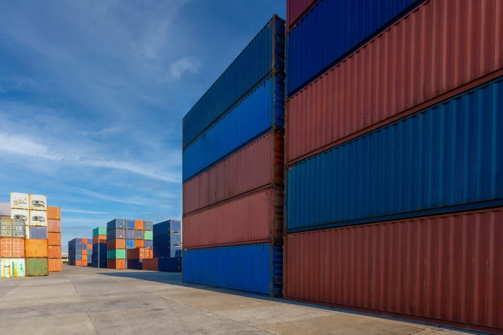 Stack of containers in a harbor. Shipping containers stacked on cargo ship.
